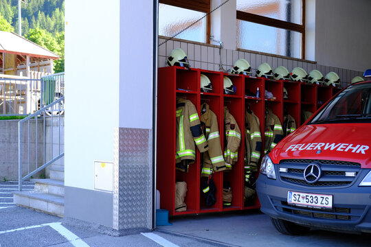 fire station building with red fire truck and firefighters uniform, voluntary fire brigade in Austria, volunteering concept, fire fighting and community assistance, Pertisau, Austria - June 2022