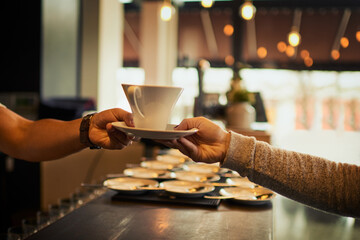 Fototapeta na wymiar Coffee shop customer, people and barista hands with tea cup, latte or matcha for client morning hydration. Restaurant store sale, cafe server and waiter giving woman drink, diner beverage or espresso