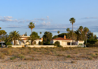 House on coastline. Real Estate Penthouse apartments. Residential building on Beachfront. Suburb house at sea. Villa at Spain seaside. Coast Home in residential area at shore. Waterfront vacation home