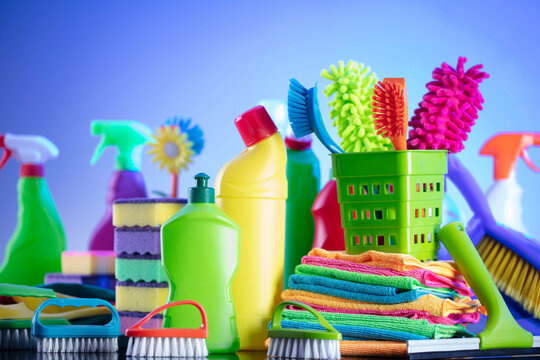 Spring cleaning. Cleaning products. Colorful cleaning kit on blue background.