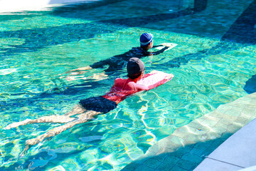Hydrotherapy concept. Asian woman and man exercising in the pool