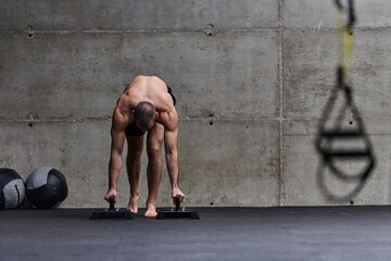 A muscular man in a handstand position, showcasing his exceptional balance and body control while...