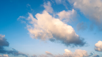 Naklejka premium Beautiful view of blue sky with clouds. Beautiful shapes, partly cloudy. Colorful sunset. Natural sky background texture, beautiful color.