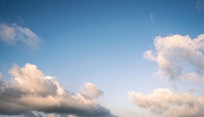 Obraz premium Beautiful view of blue sky with clouds. Beautiful shapes, partly cloudy. Colorful sunset. Natural sky background texture, beautiful color.