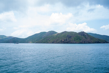 Ben Dam Port in Con Dao island, Vietnam with beautiful blue sea blue sky mountain and colorful boats.