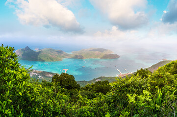 Obraz premium Ben Dam Port in Con Dao island, Vietnam with beautiful blue sea blue sky mountain and colorful boats.