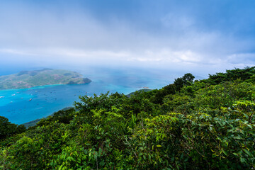 Obraz premium Ben Dam Port in Con Dao island, Vietnam with beautiful blue sea blue sky mountain and colorful boats.