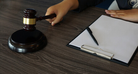 Legal counsel presents to the client a signed contract with gavel and legal law. Justice and lawyer law of advisor Concepts