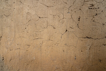 Soil wall texture of old clay house structure. Mud background. Soft picture, vintage tone.
