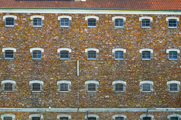 Cell windows aligned on the stone wall of the former prison of the city center of Meaux in the...