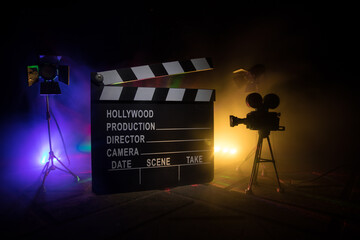 Movie concept. Miniature movie set on dark toned background with fog and empty space. Silhouette of...