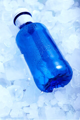 Blue water bottle in ice cubes very cold in vertical