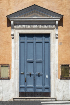An old decorated vintage door in historical centre of Rome, Italy