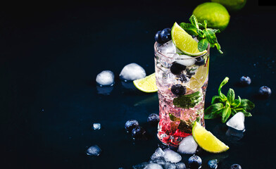 Blueberry Mojito classic alciholic cocktail drink with lime, white rum, soda, cane sugar, mint, and...