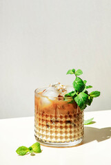 Mint White Russian alcoholic cocktail drink with vodka, coffee liqueur, mint schnapps, cream and...