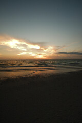 Sunset dark at Florida beach. Calm water with yellow sky from sun. Pass-a-Grille beach