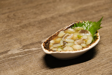 close up a plate of Tako Wasabi (Octopus and Wasabi) on wooden table. Octopus appetizer in Japan