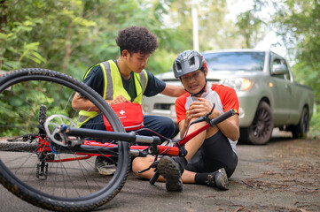 Car accident with MTB mountain bike rider and first aid : Young Asian man driving a car crashes into a cyclist falls and injured his knee, first aid to a cyclist who is injured by being hit. car crash