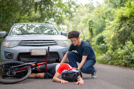 Car accident with MTB mountain bike rider and first aid : Young Asian man driving a car crashes into a cyclist falls and injured his knee, first aid to a cyclist who is injured by being hit. car crash