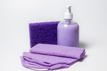 Obraz na płótnie Canvas Liquid soap, bath sponge and washcloth on a white background. Hygiene product.