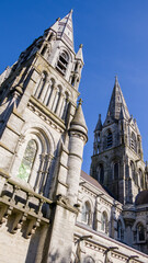 The tall Gothic spire of an Anglican church in Cork, Ireland. Neo-Gothic Christian architecture. Cathedral Church of St Fin Barre, Cork - One of Ireland’s Iconic Buildings.