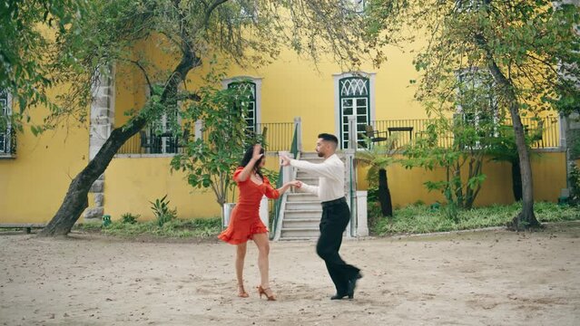Couple professionals performing latino dance in city park. Artists dancing salsa