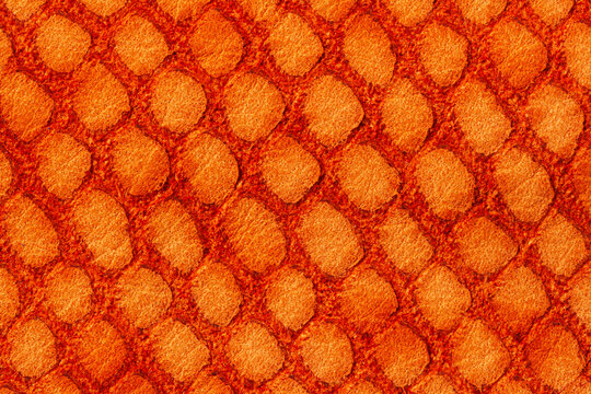 Bright orange leather texture with imitation of exotic reptile, trendy background