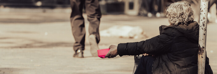 A beggar sits on the street