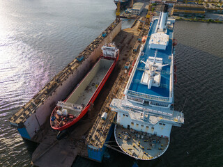 aerial view shipyard dry dock maintenance and repair cargo ship transport and oil ships in sea