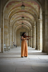 Lovely black woman playing violin in the street in Paris