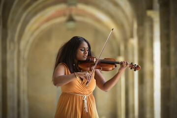 Lovely black woman playing violin in the street in Paris