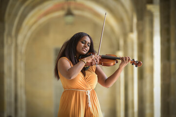 Lovely black woman playing violin in the street in Paris