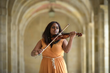 Lovely black woman playing violin in the street in Paris