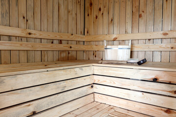 Fototapeta na wymiar Front view of empty Finnish sauna room. Modern interior of wooden spa cabin with dry steam