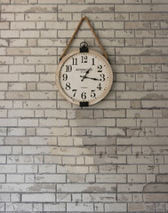 Fototapeta na wymiar Beautiful rustic clock hung on a brick wall in vintage style