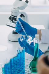 medical or scientific researcher researching and experimenting Multi-colored solution, vial and...