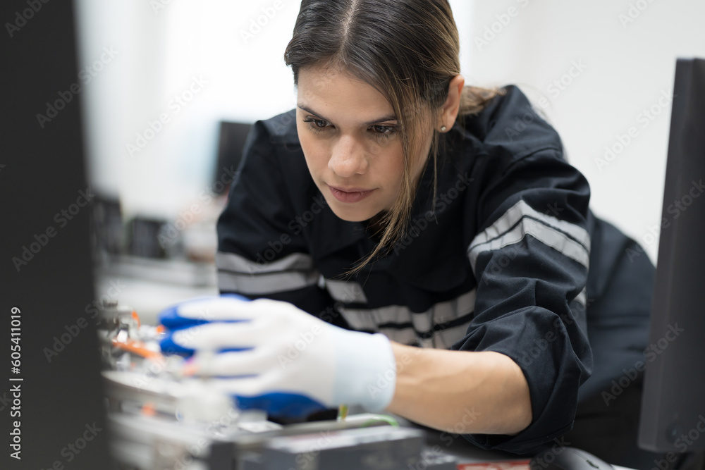 Wall mural female engineer assembling computer parts and mechatronics engineering in manufacturing automation a