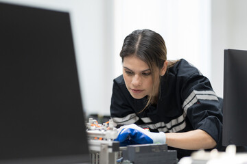 Female engineer assembling computer parts and mechatronics engineering in manufacturing automation...
