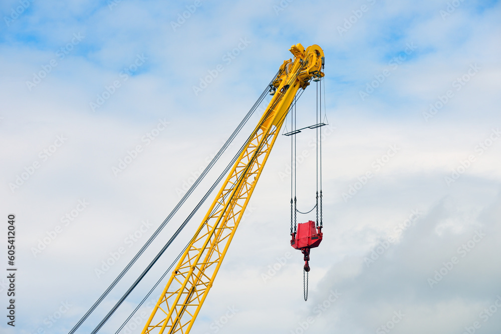 Wall mural crane boom against the blue sky