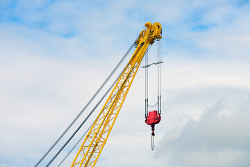 crane boom against the blue sky - Powered by Adobe