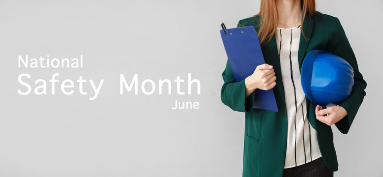 Banner for National Safety Month with female engineer holding hardhat and clipboard - Powered by Adobe