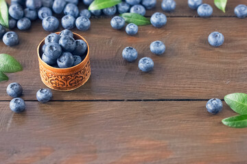 ripe fresh blueberries in a small bowl on the table close-up. background with fresh blueberries.