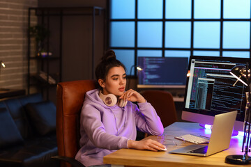 Young female programmer working in office