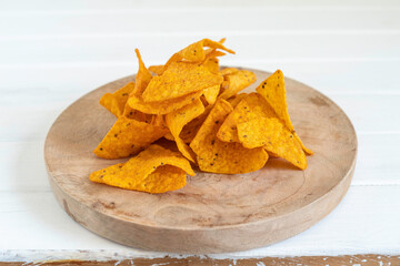 Tortilla chips on wooden background.