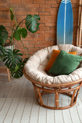 Obraz na płótnie Canvas Cozy armchair with cushions in interior of living room