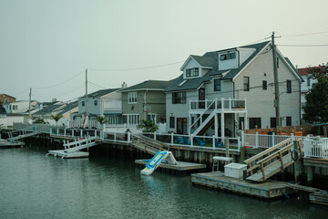 Fototapeta na wymiar Canal with house and boats in Long Beach, New York