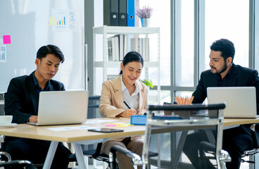 Close up manager discuss with young Asian business man and woman in meeting room of their office with day light.