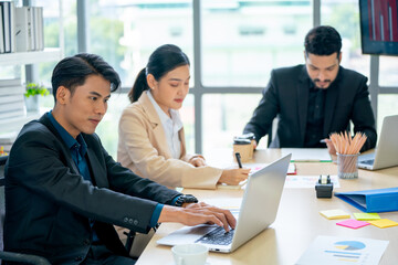 Group of Asian business men and woman work together in office with day light.
