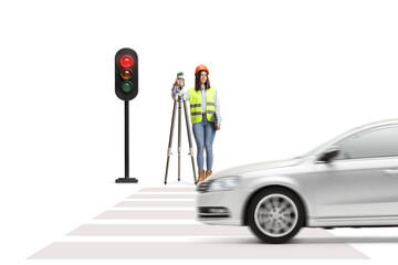 Female geodetic surveyor with a measuring device waiting at traffic lights