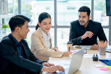 Group of Asian business men and woman work together in office with day light and happiness.